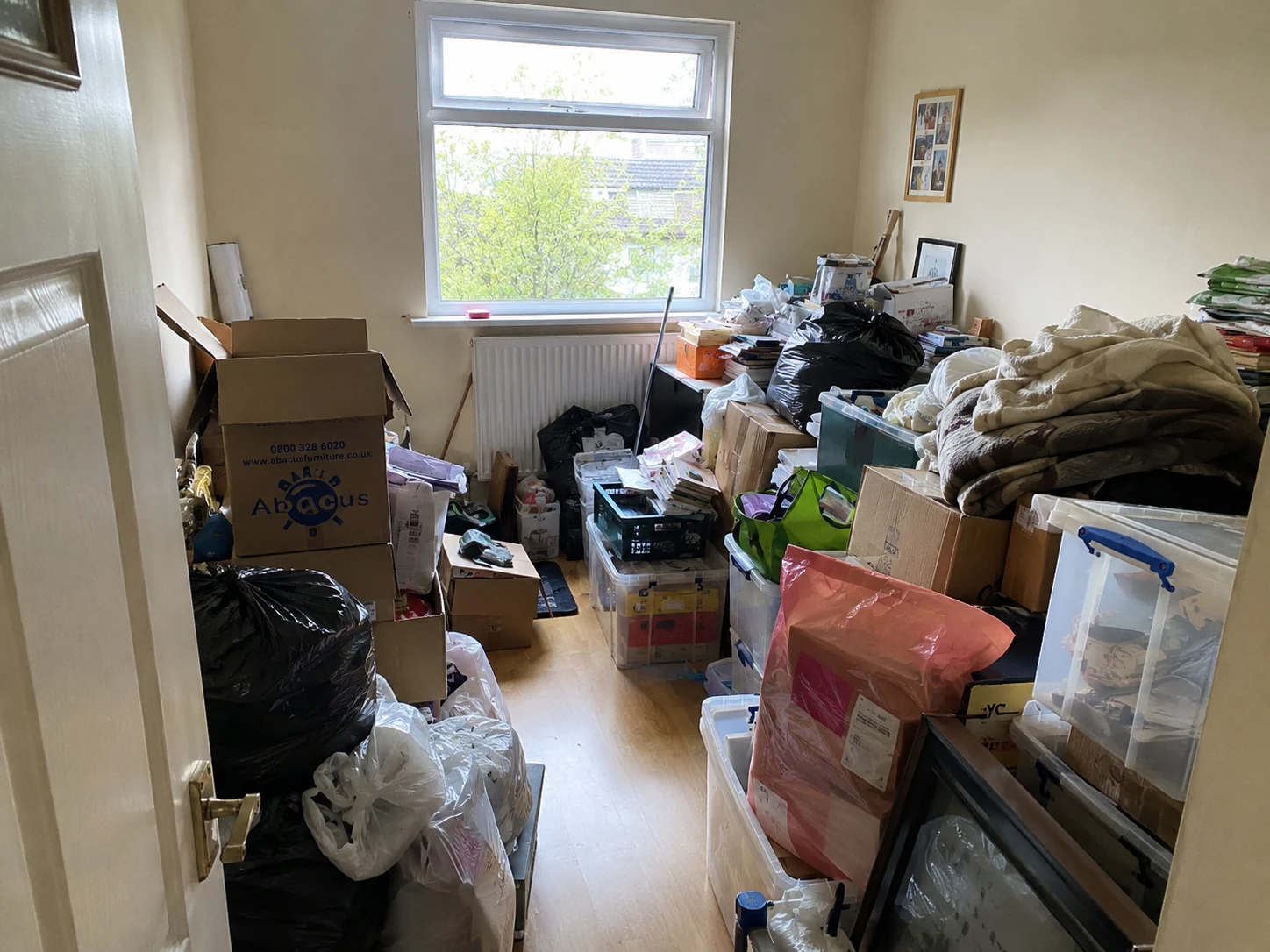 Cluttered room before hoarder clearance and cleaning